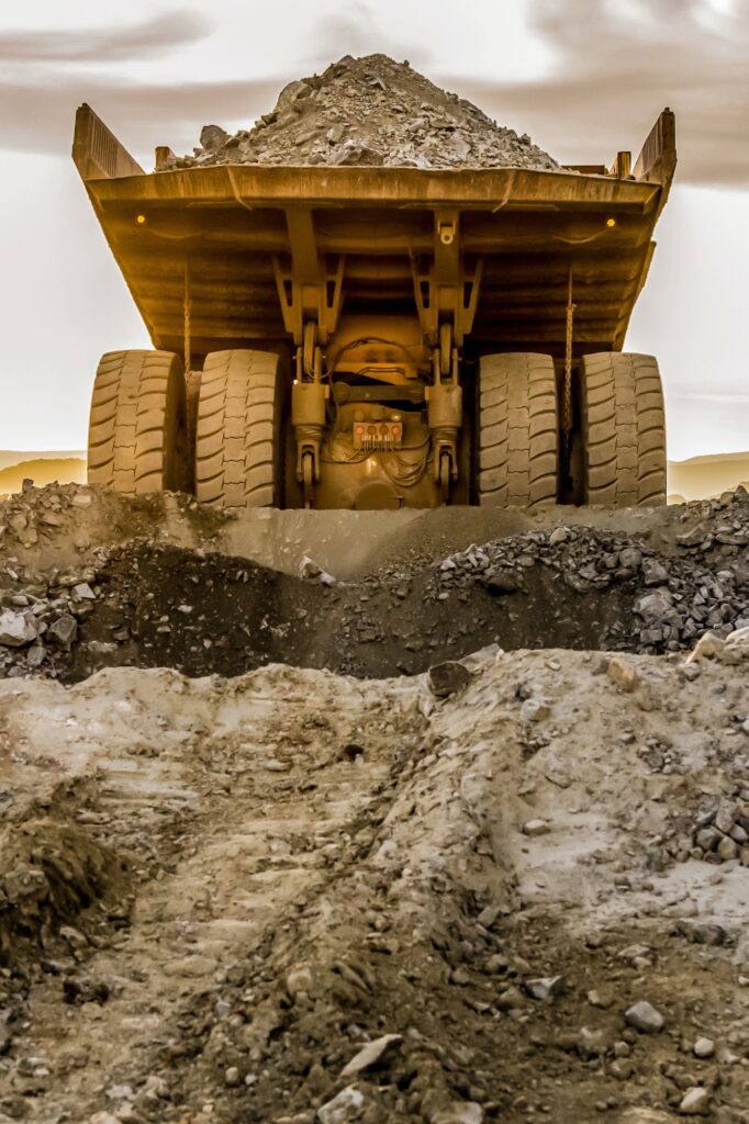 Truck loaded with crushed rock fragments for transporting in platinum mining open pit South Africa