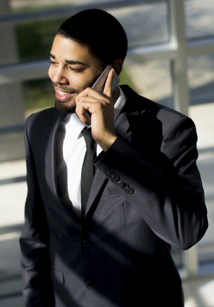 Young black man with telephone in the office